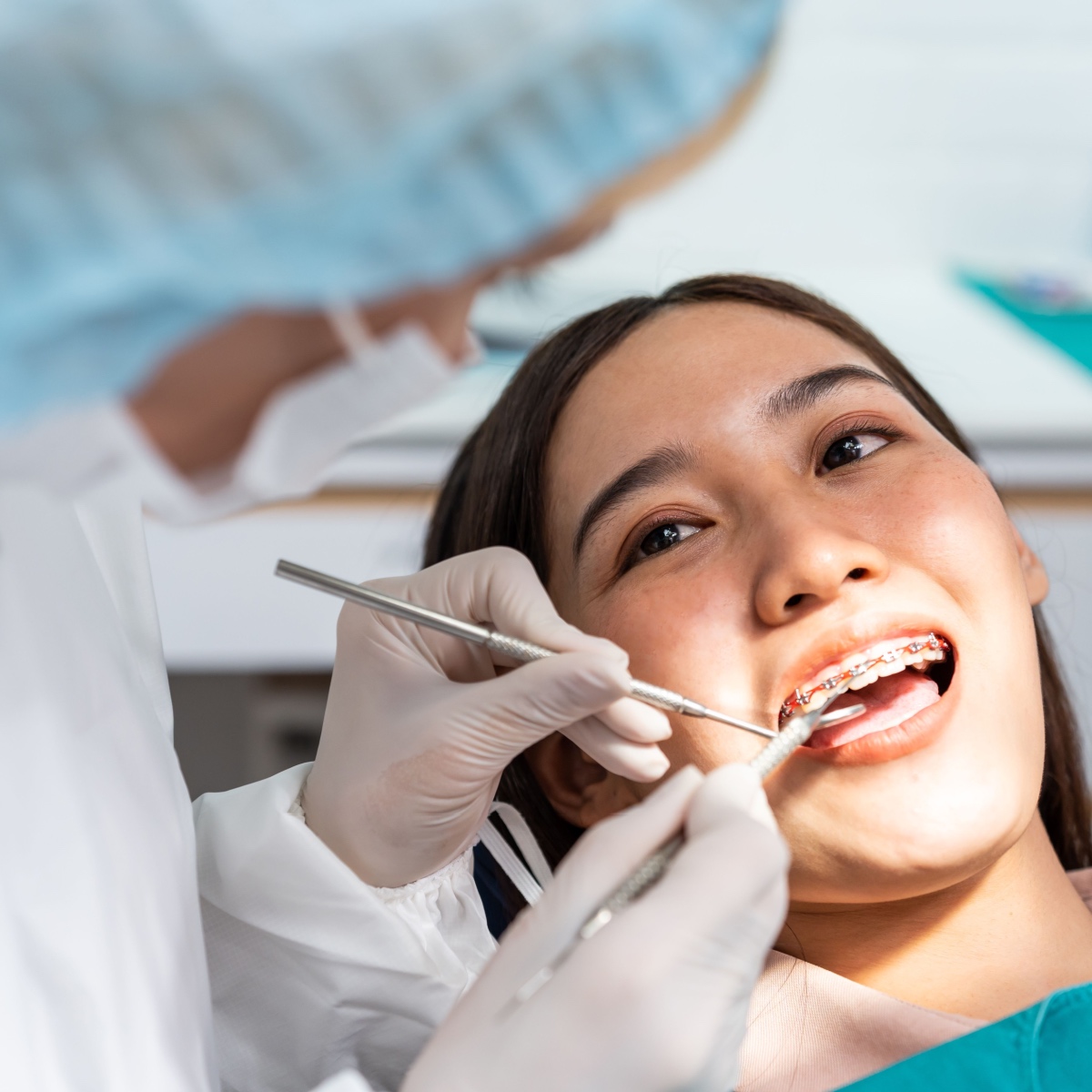 A patient getting treated by an orthodontist who uses the OrthoPhoto app